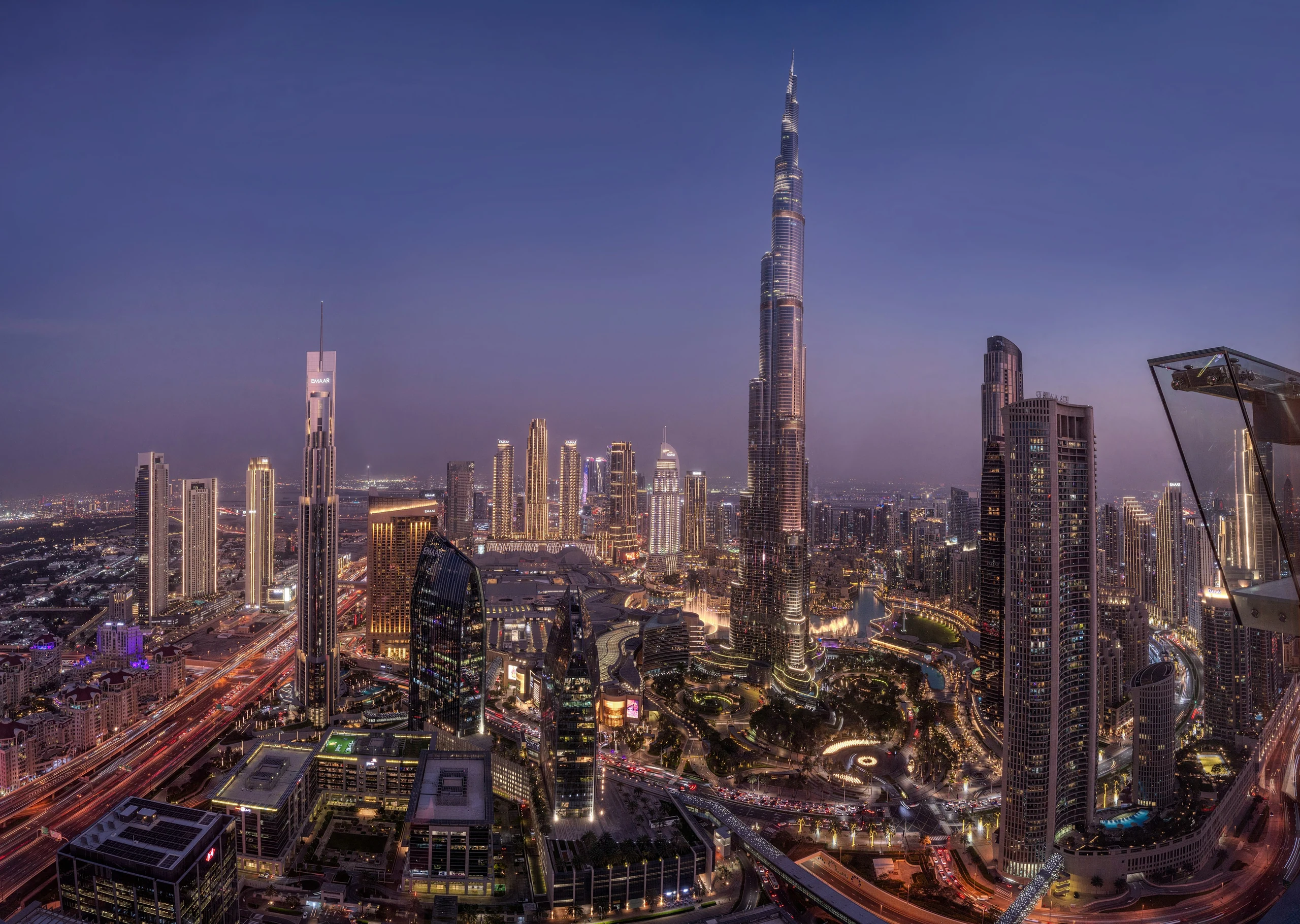 Dubai skyline at blue hour, with the Burj Khalifa above the illuminated city.